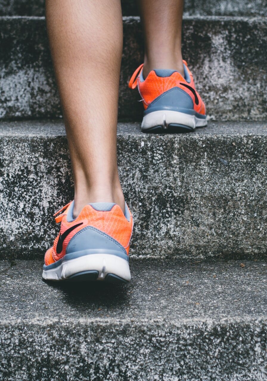 Closeup of person's shoes walking up stairs