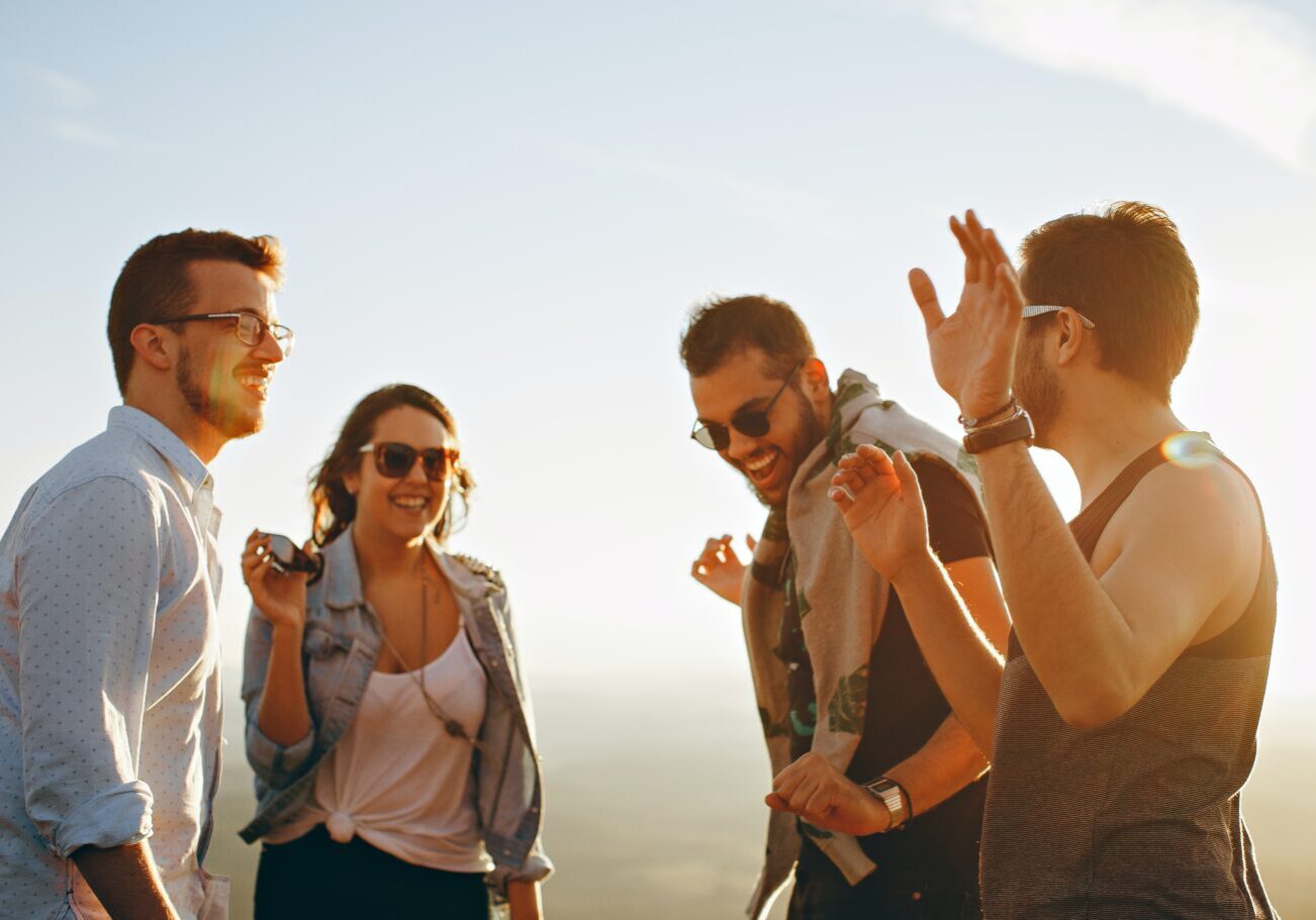 helena-lopes-e3OUQGT9bWU-unsplash Group of four young adults laughing