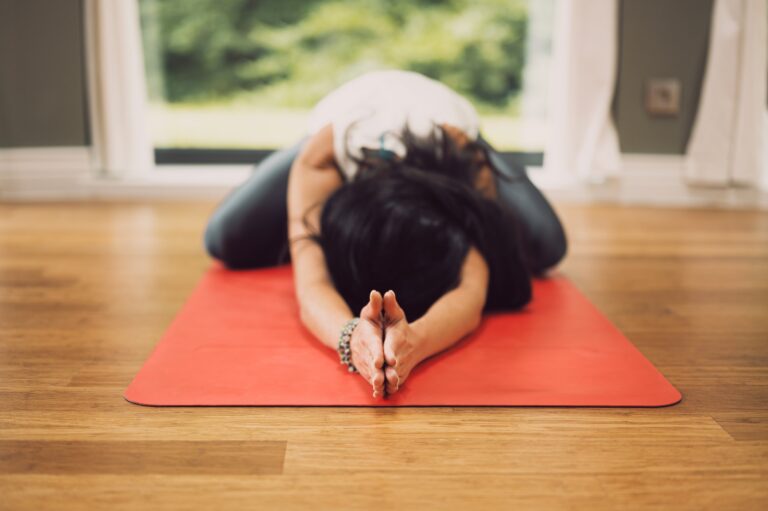 Person doing yoga on red mat